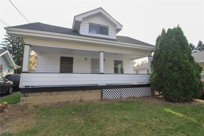 View of front of house featuring a front yard and covered porch | Image 1