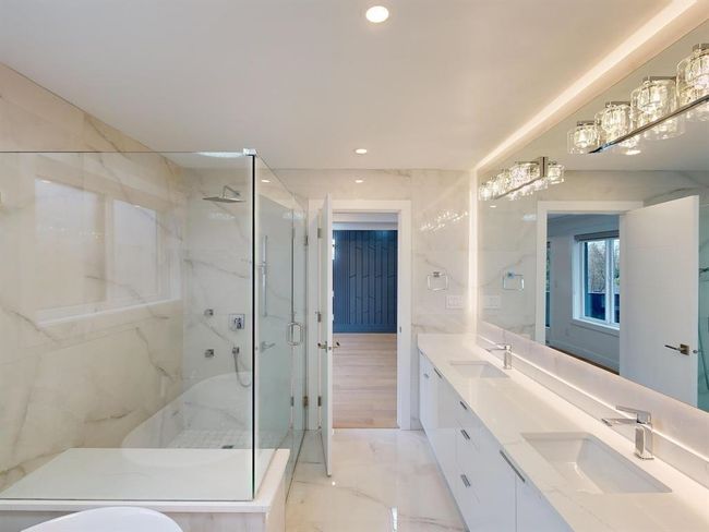 Bathroom with a marble finish shower, double vanity, recessed lighting, and marble finish flooring | Image 31