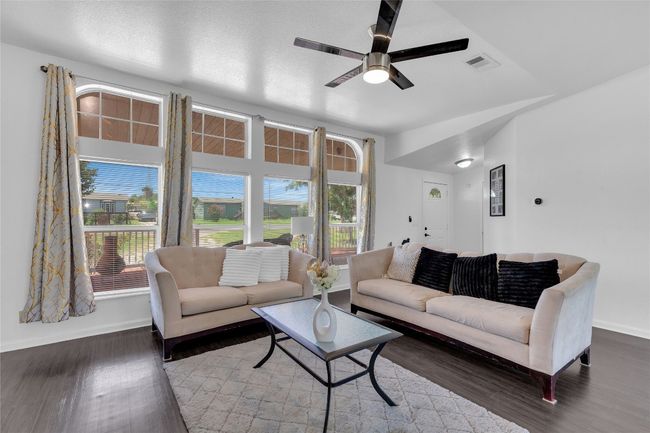 Living room with wood finished floors and ceiling fan | Image 5