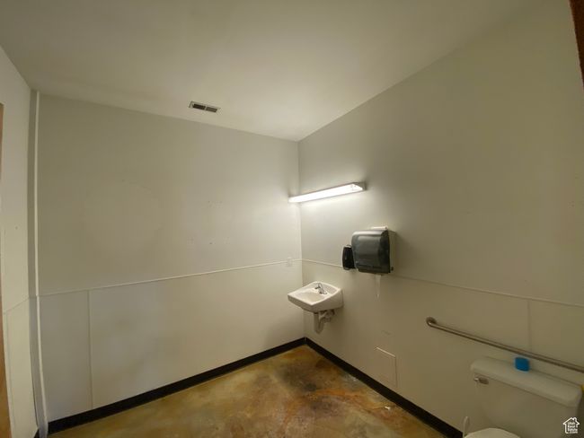 Half bath featuring toilet, concrete floors, and visible vents | Image 27