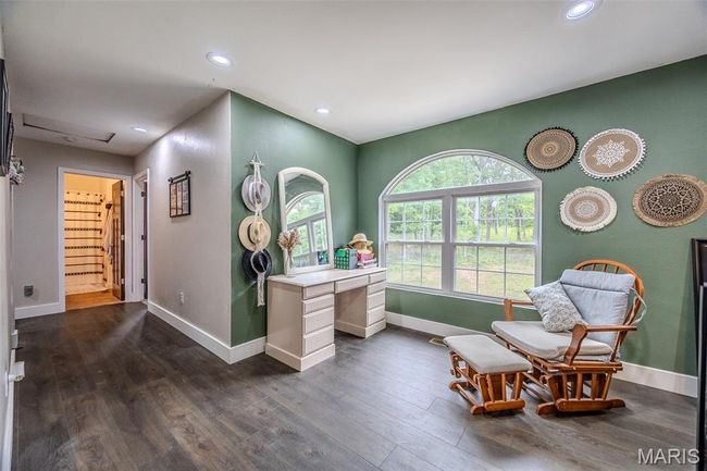 Sitting room with dark wood finished floors, an office area, and recessed lighting | Image 41
