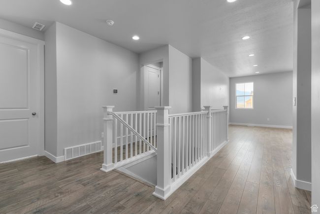 Corridor featuring an upstairs landing, hardwood / wood-style floors, and recessed lighting | Image 4