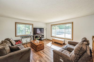 The living room features stunning floors and is filled with natural light, creating a warm and welcoming atmosphere. | Image 3