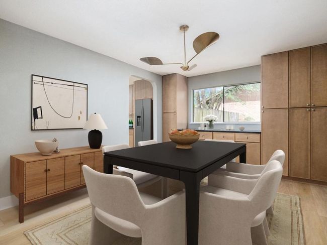 Dining area with arched walkways and light wood-type flooring | Image 4