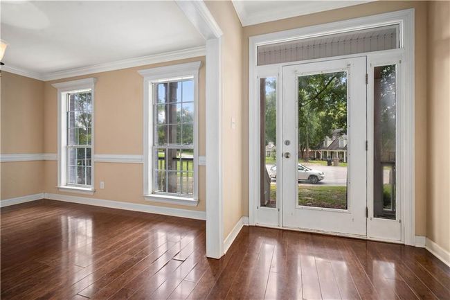 Entrance foyer with hardwood / wood-style flooring, healthy amount of natural light, and crown molding | Image 13