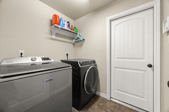 Laundry area with washer and clothes dryer and a textured ceiling | Image 25