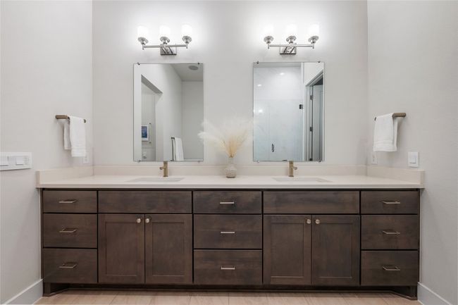 Elegant ensuite oversized primary bathroom features quartz countertops, dual vanity, soaking tub, walk-in shower and walk-in closet. | Image 13