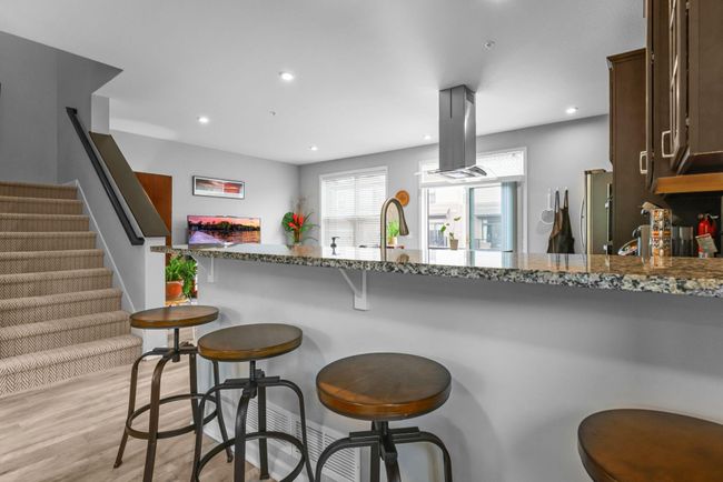 Have a seat! Eat-in style kitchen with granite counters. | Image 10