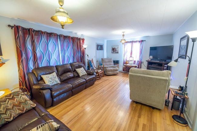 Living room with wood-type flooring | Image 8