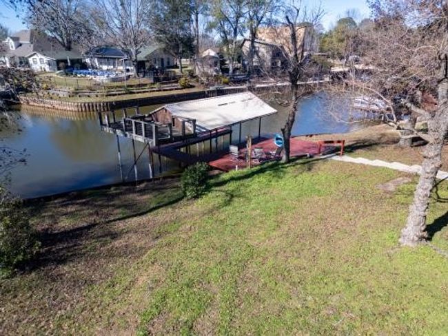 Dock area with a water view and a lawn | Image 7