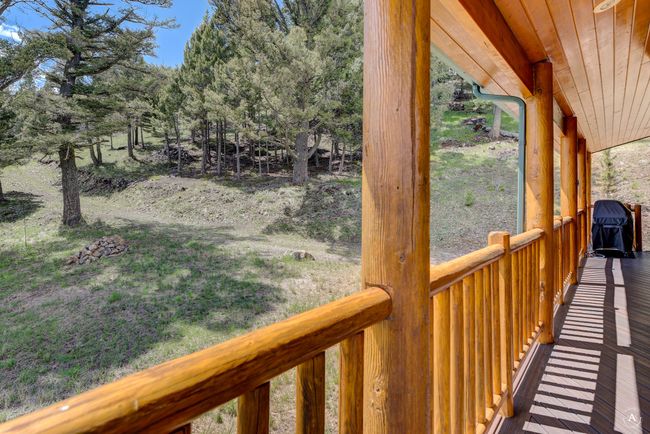 Wooden deck with view of wooded area | Image 41