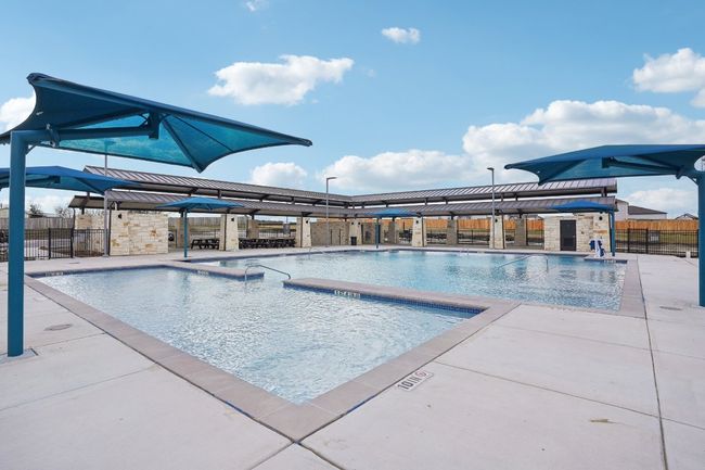 Community pool with fence and a patio | Image 18