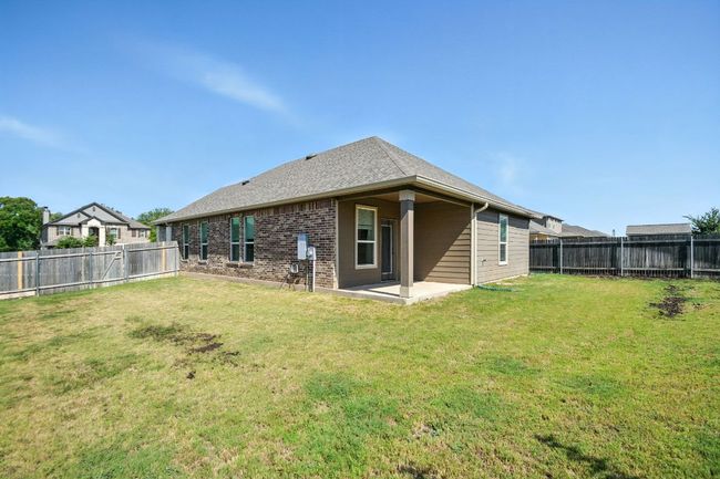 Rear view of property with a patio, a fenced backyard, brick siding, and roof with shingles | Image 28