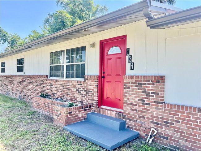 Doorway to property featuring brick siding | Image 33