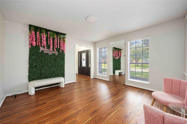 Extended foyer space with a large window, ideal for welcoming guests or as a relaxing lounge area. | Image 20