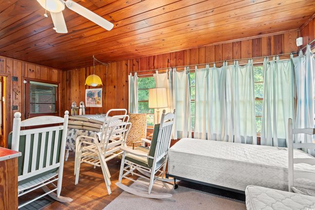 Dining area with wooden walls, wooden ceiling, and a ceiling fan | Image 17
