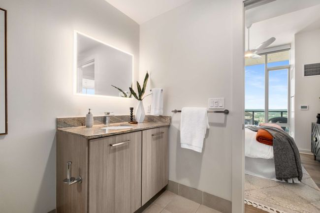 The bathroom features Brazilian granite countertops and a backlit mirror for that extra dose of luxury. | Image 29