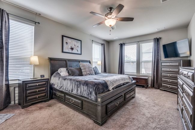 Primary bedroom with great natural light and a ceiling fan. | Image 10