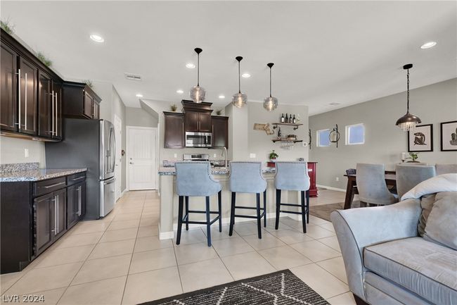Kitchen features custom pendant lighting and espresso cabinets | Image 13