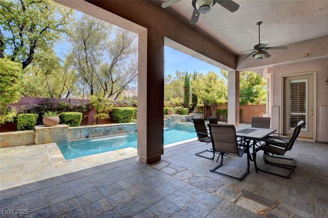 View of pool with a patio, outdoor dining space, ceiling fan, and a fenced backyard | Image 44