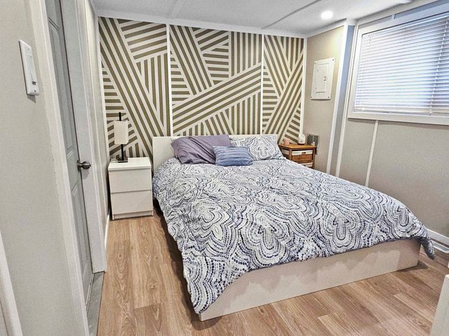 Bedroom featuring wood finished floors and baseboards | Image 9