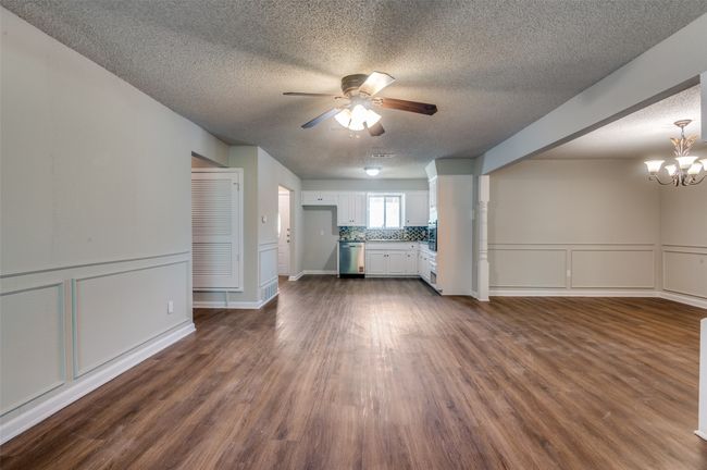 Living room flowing into the dining room and kitchen. | Image 6