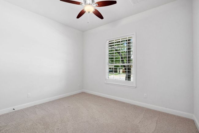 Bedroom 2 - Each bedroom offers a ceiling fan. | Image 26