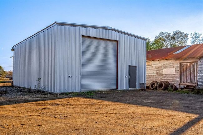 The property is partially wooded for privacy and partially fenced. | Image 18