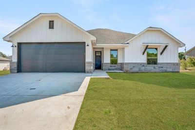 View of front of house with a front lawn and a garage | Image 1