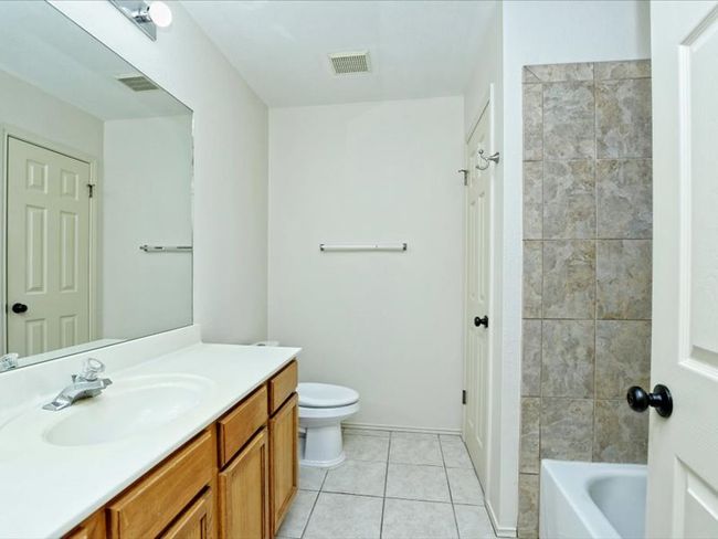 Full bathroom featuring visible vents, toilet, tile patterned flooring, and vanity | Image 15