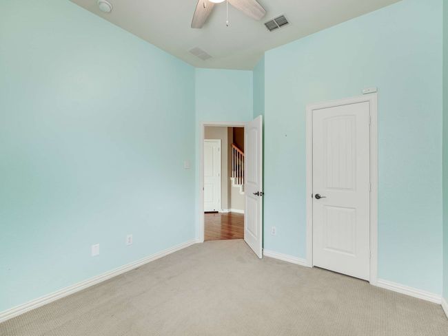 Unfurnished bedroom with light colored carpet and a ceiling fan | Image 25