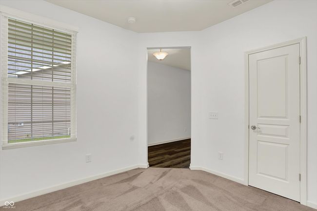 carpeted spare room with plenty of natural light and a smoke detector | Image 4