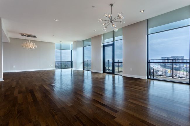 Living room looking towards expansive dining room & large balcony. | Image 9