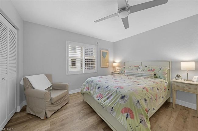 Bedroom with light wood-type flooring, a closet, and ceiling fan | Image 34