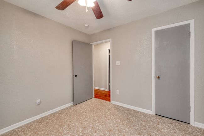 Bedroom 3 with 2 single windows replaced in Jan 2025, vinyl flooring, and baseboards and a ceiling fan | Image 19
