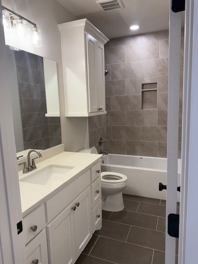 Full bathroom featuring vanity, tile patterned floors, shower / bathtub combination, and recessed lighting | Image 22