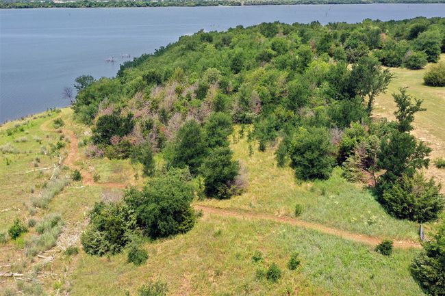 Permitted walking trail leads to the water's edge through a gated access from the property. Easy access for bringing your fishing gear or to launch your canoes or kayaks. | Image 35