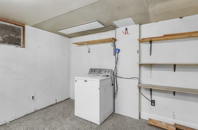 Laundry area featuring washer / dryer and light colored carpet | Image 31