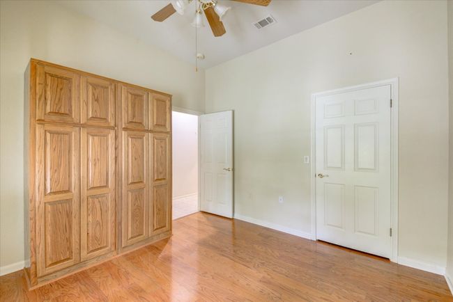 Bedroom 3 featuring light wood-type flooring, high vaulted ceiling, and ceiling fan | Image 23