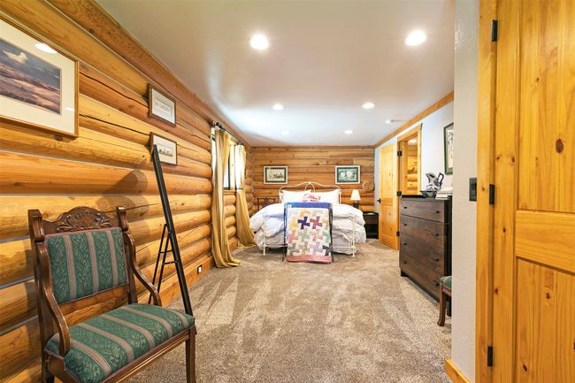 upstairs bedroom featuring rustic walls and recessed lighting | Image 28