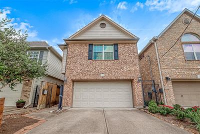 Charming two-story brick residence with pristine upkeep, featuring a spacious two-car garage and elegant dark shutter accents. | Image 2