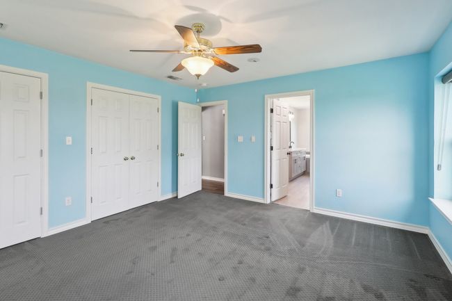 Unfurnished bedroom featuring carpet flooring, baseboards, a closet, and visible vents | Image 15