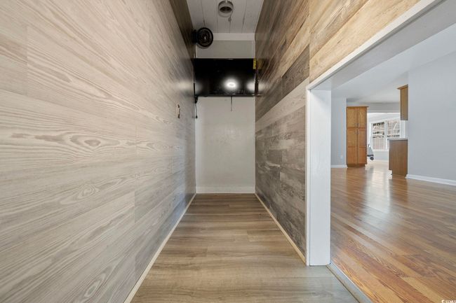 Hallway with wood finished floors and baseboards | Image 35
