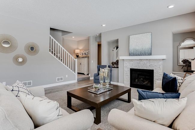 Family room with gas fireplace, abundant space to gather. Photo of model home, color & options may vary. | Image 8