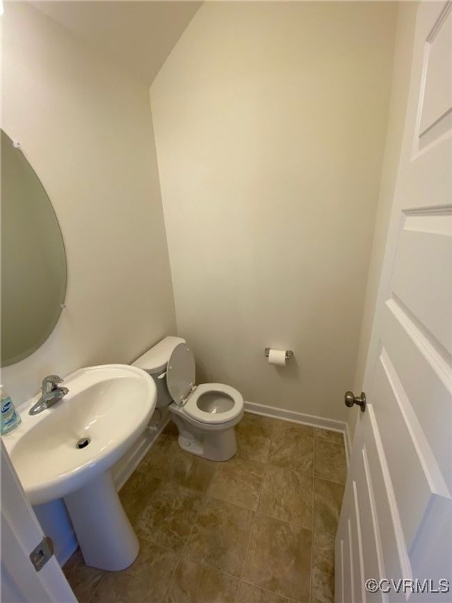 Bathroom with toilet, a sink, and baseboards | Image 7