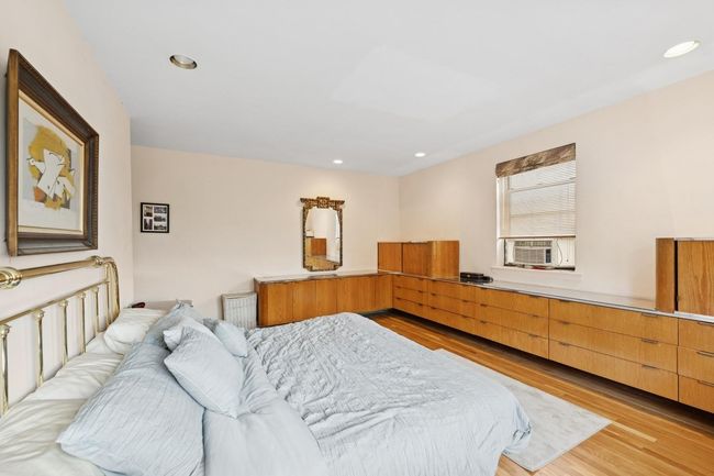 Bedroom featuring light wood-style floors, cooling unit, and recessed lighting | Image 14