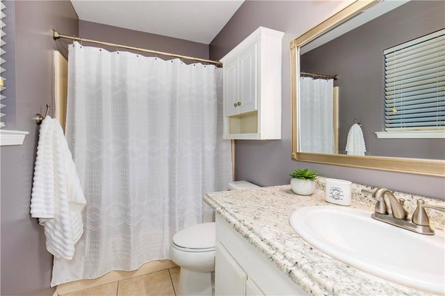 Full bath with vanity, tile patterned flooring, and a shower with shower curtain | Image 15