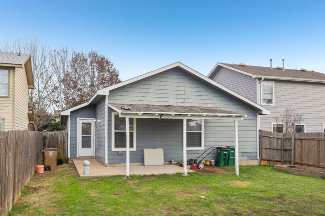 Rear view of house with a yard, a fenced backyard, and a patio area | Image 20