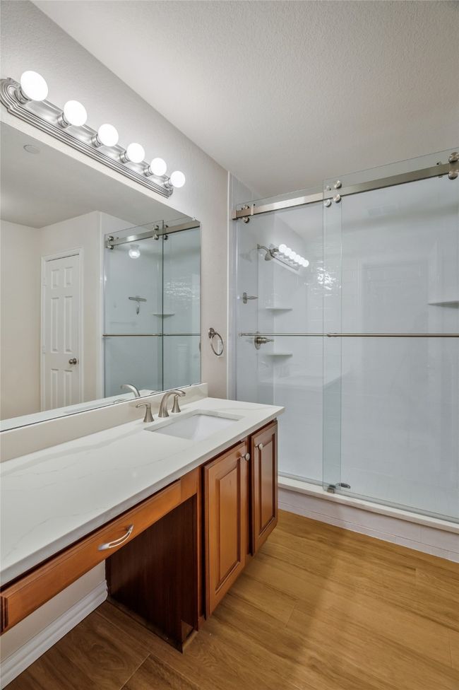 Bathroom with oversized vanity, and an updated walk-in shower. Linen closer, too. | Image 24