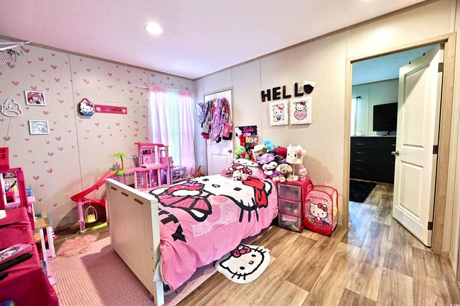 flex room with light wood-style floors, a textured ceiling, and crown molding | Image 21